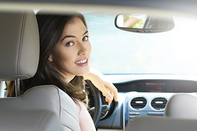 Woman looking back in car